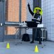 Eric Ruiz standing behind a table with a drone and laptop on it