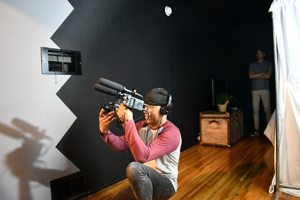 Eric Ruiz filming with a camera in his hand