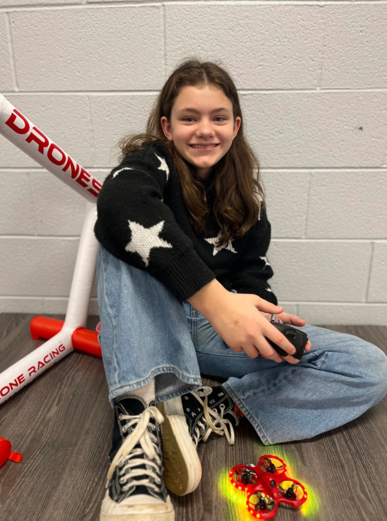Young female student holding a drone controller