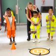 Young kids putting on neon-colored safety vests