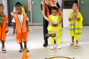 Young kids putting on neon-colored safety vests