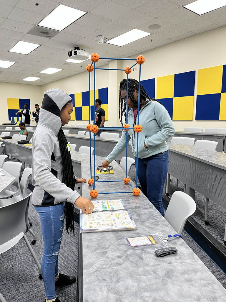 Young students putting together their drone kit