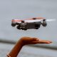Child's hand releasing a drone