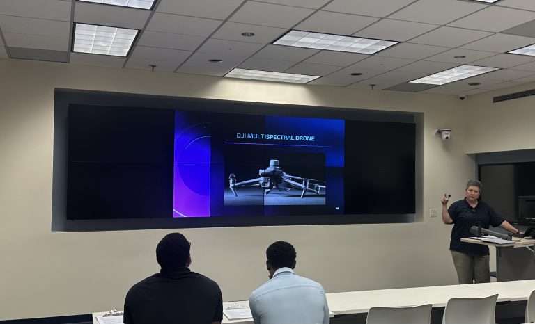 Woman teaching students at Florida International University about drone technology and applications.