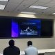 Woman teaching students at Florida International University about drone technology and applications.
