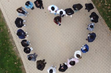 Young girls form a heart; image taken by a drone from an aerial view.