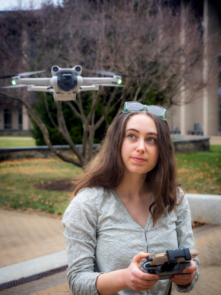woman flying a drone outdoors