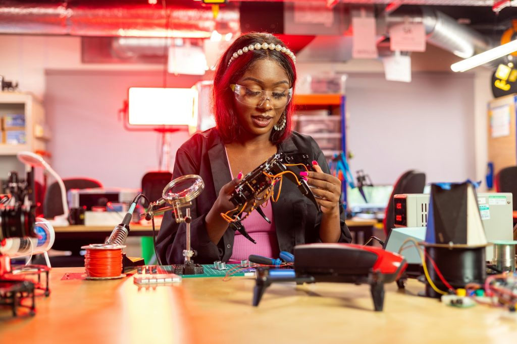 Female engineering student working on a drone